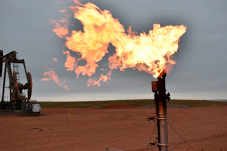 A flare burns natural gas at an oil well, Aug. 26, 2021, Watford City, N.D.