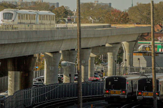 The JFK airport Airtrain, left, on overhead tracks above Long Island Rail Road trains near Jamaica Station, Queens, N.Y., Nov. 1, 2012.
