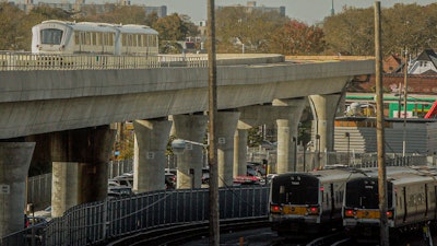 The JFK airport Airtrain, left, on overhead tracks above Long Island Rail Road trains near Jamaica Station, Queens, N.Y., Nov. 1, 2012.