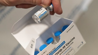 A pharmacist holds a vial of the Johnson & Johnson COVID-19 vaccine at a hospital in Bay Shore, N.Y., March 3, 2021.