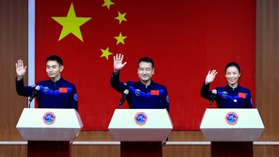 Chinese astronauts, from left, Ye Guangfu, Zhai Zhigang and Wang Yaping at the Jiuquan Satellite Launch Center, Oct. 14, 2021.