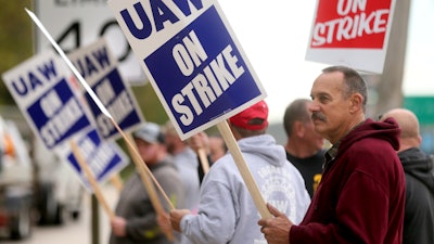 John Deere Dubuque Works union employee Steve Thor pickets outside UAW Local 94 in Dubuque, Iowa, Oct. 14, 2021.