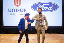 Unifor President Jerry Dias, left, elbow bumps Ryan Kantautas, Vice President of Human Resources at Ford Canada, at the start of formal contract talks in Toronto, Aug. 12, 2020.