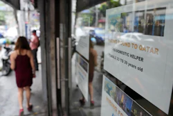 A sign about hiring domestic helpers in the Middle East outside an office in Manila, Philippines, Oct. 21, 2021.