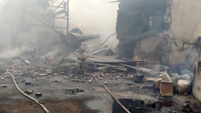 Emergency personnel work at the site of an explosion and fire at a gunpowder factory in the Ryazan region of Russia, Oct. 22, 2021.