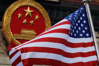 An American flag flown next to the Chinese national emblem during a welcome ceremony, Nov. 9, 2017.