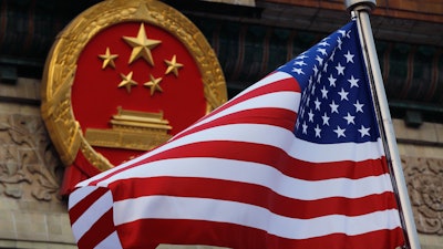 An American flag flown next to the Chinese national emblem during a welcome ceremony, Nov. 9, 2017.