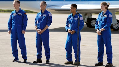 From left, European Space Agency astronaut Matthias Maurer, and NASA astronauts Tom Marshburn, Raja Chari and Kayla Barron speak to the media at Kennedy Space Center, Cape Canaveral, Fla., Oct. 26, 2021.