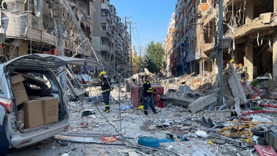 In this photo released by Xinhua News Agency, policemen and firefighters walk through damaged shophouses following a gas explosion in Shenyang in northeastern China's Liaoning Province, Thursday, Oct. 21, 2021. Several people were killed and over dozen injured in the gas explosion at a restaurant in northeastern Chinese city Shenyang Thursday morning, according to local authorities.