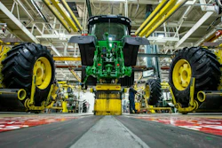 Wheels are attached as workers assemble a tractor at John Deere's Waterloo, Iowa assembly plant, April 9, 2019.