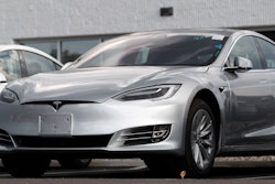 This July 8, 2018 photo shows Tesla 2018 Model 3 sedans sit on display outside a Tesla showroom in Littleton, Colo. Tesla wants to keep secret its response to the U.S. government’s request for information in an investigation of its Autopilot partially automated driving system.