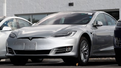 This July 8, 2018 photo shows Tesla 2018 Model 3 sedans sit on display outside a Tesla showroom in Littleton, Colo. Tesla wants to keep secret its response to the U.S. government’s request for information in an investigation of its Autopilot partially automated driving system.