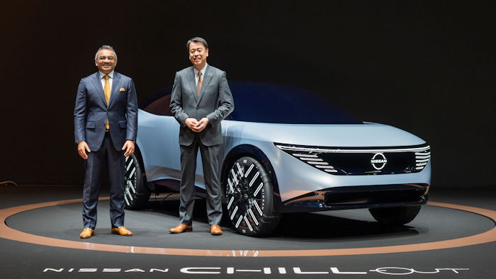 In this photo provided by Nissan Motor Co., Chief Executive Makoto Uchida, right, and COO Ashwani Gupta, left, pose with a Nissan Chill-Out concept car on Nov. 27, 2021.