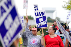 Members of the United Auto Workers strike outside of a John Deere plant on Oct. 20, 2021 in Ankeny, IA.
