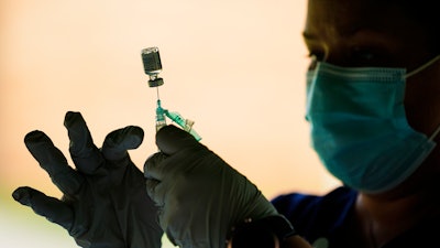 A syringe is prepared with the Pfizer COVID-19 vaccine at a clinic at Reading Area Community College, Reading, Pa., Sept. 14, 2021.