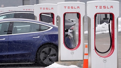 A Tesla vehicle at a charging station at a dealership in Dedham, Mass., Feb. 18, 2021.