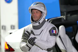 European Space Agency astronaut Thomas Pesquet of France adjusts his glove as he talks to family and friends before a launch attempt at the Kennedy Space Center, Cape Canaveral, Fla., April 23, 2021.