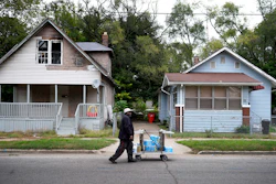 Sylvester Bownes walks with bottled and jugs full of water, Benton Harbor, Mich., Oct. 21, 2021.