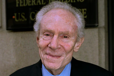 Aaron Feuerstein, president and CEO of Malden Mills, smiles outside a courthouse, on Aug 14, 2003, in Worcester, Mass.