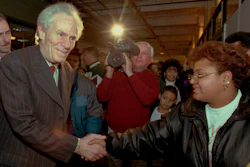 Aaron Feuerstein, left, president and owner of Malden Mills Industries Inc., in Methuen, Mass., shakes hands with workers on Jan. 11, 1996, in Lawrence, Mass.