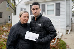 Nicole and Simon Obarto with a lead and copper analysis from the Oakland County Health Division, Royal Oak, Mich., Nov. 18, 2021.