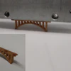 A novel polymer developed at Oak Ridge National Laboratory strengthens sand for additive manufacturing applications. A 6.5 centimeter 3D-printed sand bridge, shown here, held 300 times its own weight.