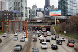 In this March 31, 2021 file photo, traffic flows along Interstate 90 highway as a Metra suburban commuter train moves along an elevated track in Chicago. Congress has created a new requirement for automakers: find a high-tech way to keep drunken people from driving cars.