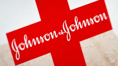 This Oct. 16, 2012 file photo shows the Johnson & Johnson logo on a package of Band-Aids, in St. Petersburg, Fla. Johnson & Johnson is splitting into two companies, separating the division that sells Band-Aids and Listerine, from its medical device and prescription drug business.