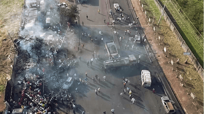 In this photograph issued Saturday Nov. 6 2021 by Sierra Leone's National Disaster Management Agency, people gather around the charred oil tanker that exploded after being struck by a truck in the Wellington suburb of Sierra Leone's capital Freetown Saturday Nov. 6, 2021. Scores died in the explosion that happened late Friday Nov. 5.