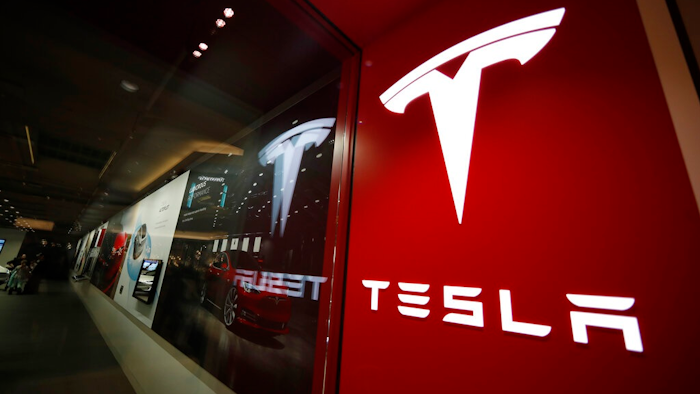 This photo shows a sign bearing the company logo outside a Tesla store Feb. 9, 2019 in Cherry Creek Mall in Denver. Tesla says it has officially moved its corporate headquarters from Silicon Valley to a large factory under construction outside of Austin, Texas. The company made the announcement late Wednesday, Dec. 1, 2021 in a filing with U.S. securities regulators.