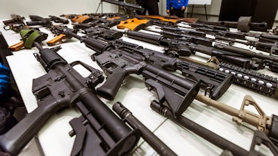 A variety of military-style semi-automatic rifles obtained during a buy back program displayed at Los Angeles police headquarters, Dec. 27, 2012.