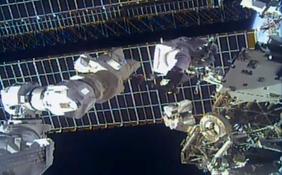 This photo provided by NASA shows astronaut Tom Marshburn replacing a broken antenna outside the International Space Station, Dec. 2, 2021.