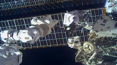 This photo provided by NASA shows astronaut Tom Marshburn replacing a broken antenna outside the International Space Station, Dec. 2, 2021.