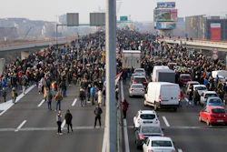 Protesters stand on the highway during a protest, Belgrade, Serbia, Dec. 4, 2021.