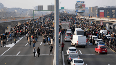 Protesters stand on the highway during a protest, Belgrade, Serbia, Dec. 4, 2021.