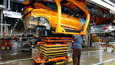 A battery is lifted into place for installation in a Chevrolet Bolt EV at the General Motors Orion Assembly plant, Nov. 4, 2016, Orion Township, Mich.