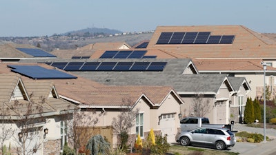 Solar panels on rooftops of a housing development in Folsom, Calif., Feb. 12, 2020.