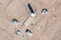 Satellite photo showing a support vehicle stands and large white gantry that typically houses a rocket at the Imam Khomeini Spaceport, Semnan province, Iran, Dec. 11, 2021.