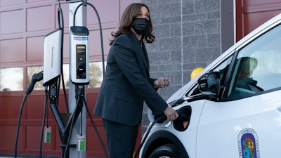 Vice President Kamala Harris charges an electric vehicle during her tour of the Brandywine Maintenance Facility in Prince George's County, Md., Dec. 13, 2021.