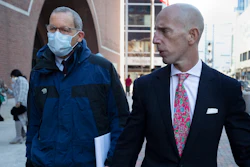 Harvard professor Charles Lieber, left, leaves federal court with his lawyer Marc Mukasey, Boston, Dec. 14, 2021.