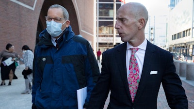 Harvard professor Charles Lieber, left, leaves federal court with his lawyer Marc Mukasey, Boston, Dec. 14, 2021.