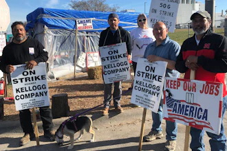 Striking Kellogg's workers Michael Rodarte, Sue Griffin, Michael Elliott, Eric Bates and Mark Gonzalez stand outside the Omaha, Neb., cereal plant, Dec. 2, 2021.