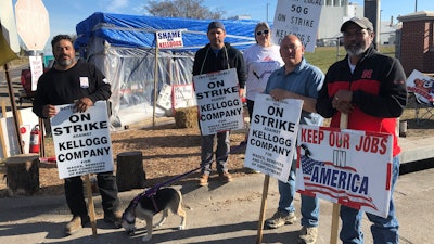 Striking Kellogg's workers Michael Rodarte, Sue Griffin, Michael Elliott, Eric Bates and Mark Gonzalez stand outside the Omaha, Neb., cereal plant, Dec. 2, 2021.