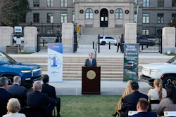 Georgia Gov. Brian Kemp, flanked by Rivian electric trucks, at a press conference in Atlanta, Dec. 16, 2021.