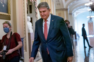 Sen. Joe Manchin, D-W.Va., walks to a caucus lunch at the Capitol in Washington, Dec. 17, 2021.