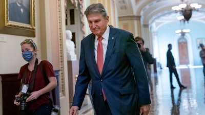 Sen. Joe Manchin, D-W.Va., walks to a caucus lunch at the Capitol in Washington, Dec. 17, 2021.