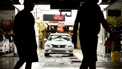 Workers at the Nissan plant in Smyrna, Tenn., walk by an Altima sedan, May 15, 2012.