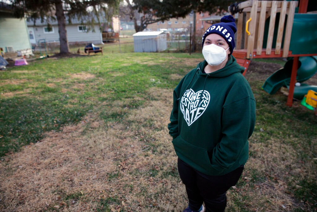 Sonja Redding, an unemployed mother of two, stands outside her home in Omaha, Nebraska on Monday, Dec. 6, 2021. Redding has been trying to find a job, but it's difficult because she feels she needs to stay at home to care for her children who have special needs and are particularly vulnerable to viruses.