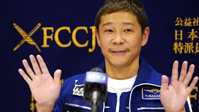 Japanese billionaire Yusaku Maezawa waves during a press conference at the Foreign Correspondents’ Club in Tokyo, Jan. 7, 2022.