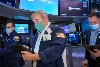 Traders Edward McCarthy, center, and Edward Curran, right, on the floor of the New York Stock Exchange, Jan. 10, 2022.